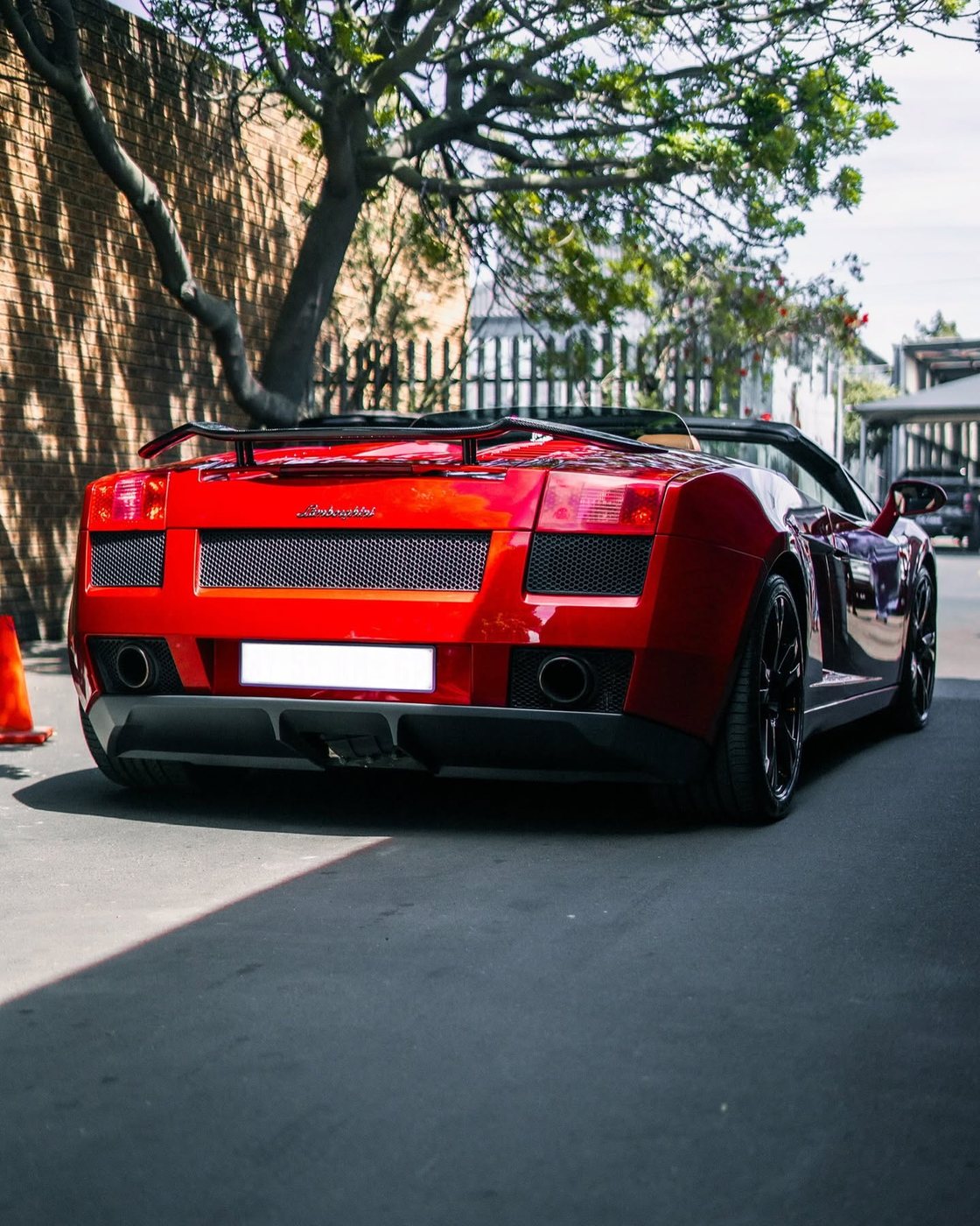 Red supercar photographed outside