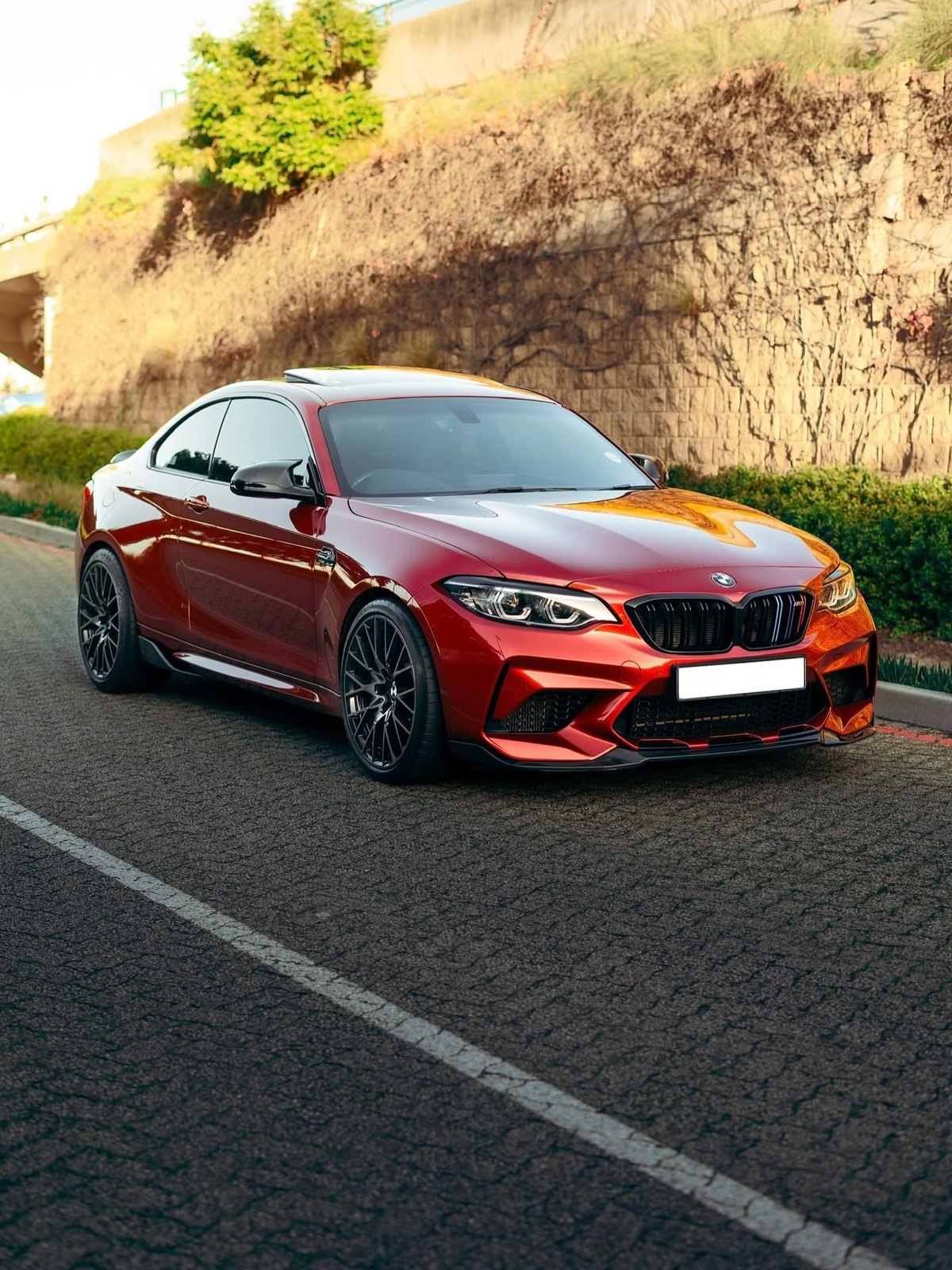 Red performance BMW photographed outdoors